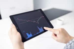 woman holding a digital tablet with stock market c 2021 09 27 15 34 15 utc